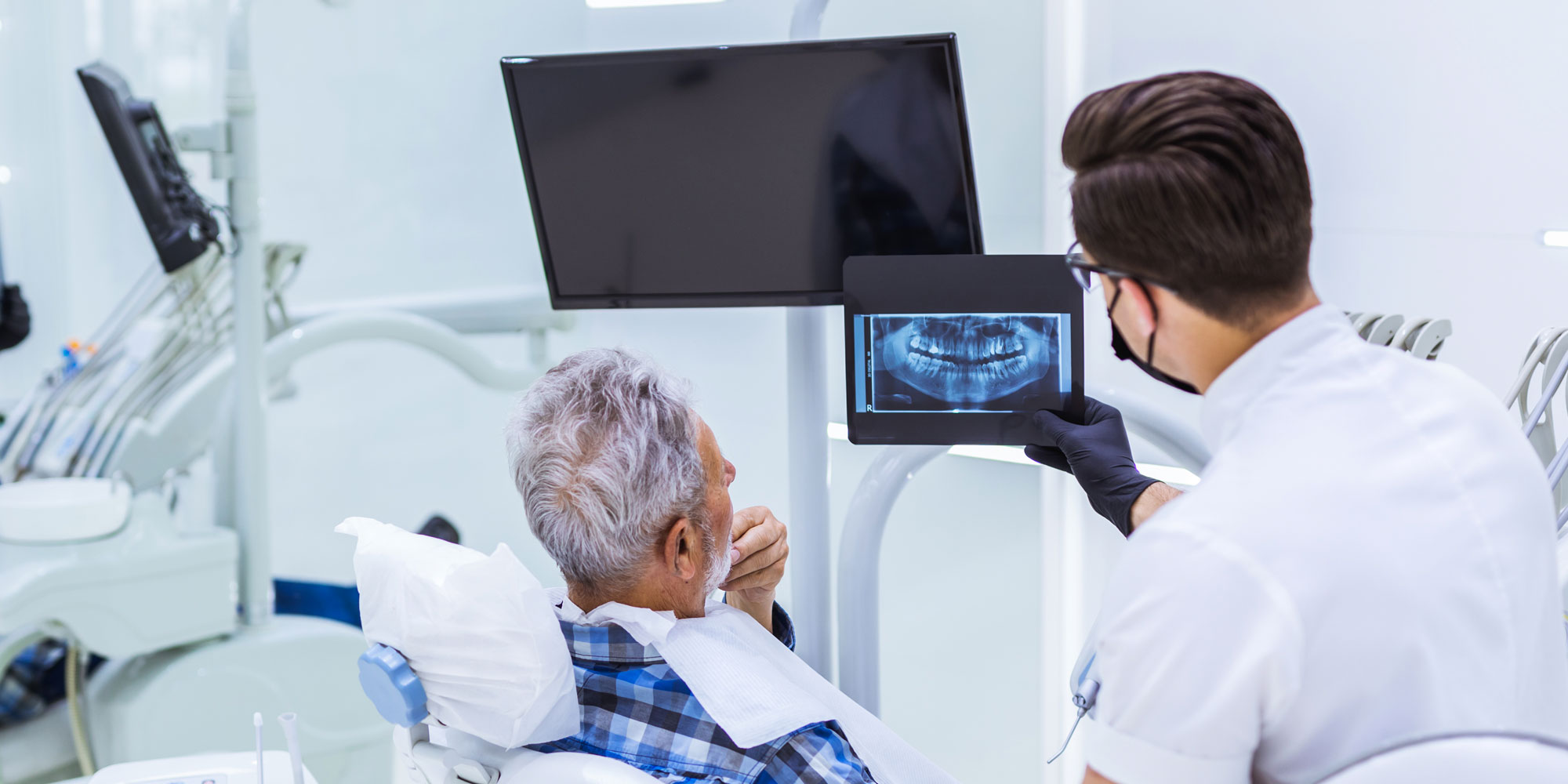dentist with patient discussing dental issues