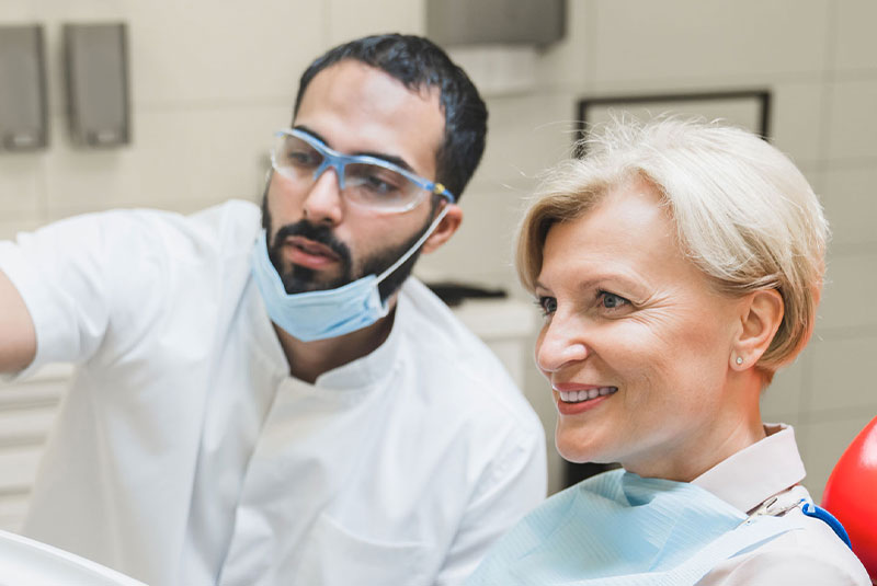 surgeon with female older implant patient showing risk factors3