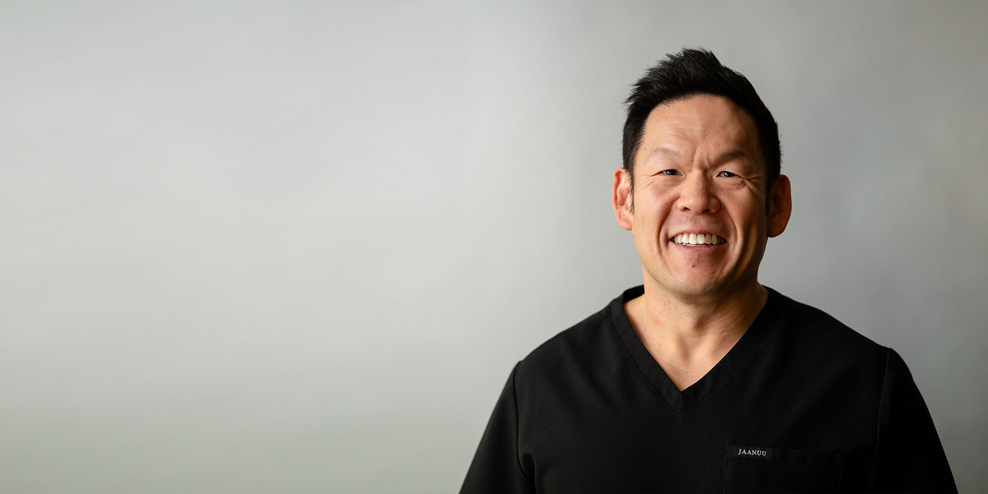 headshot of doctor smiling brightly
