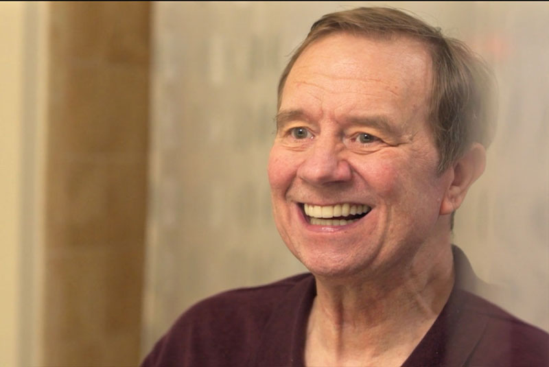 headshot of patient smiling within the dental center