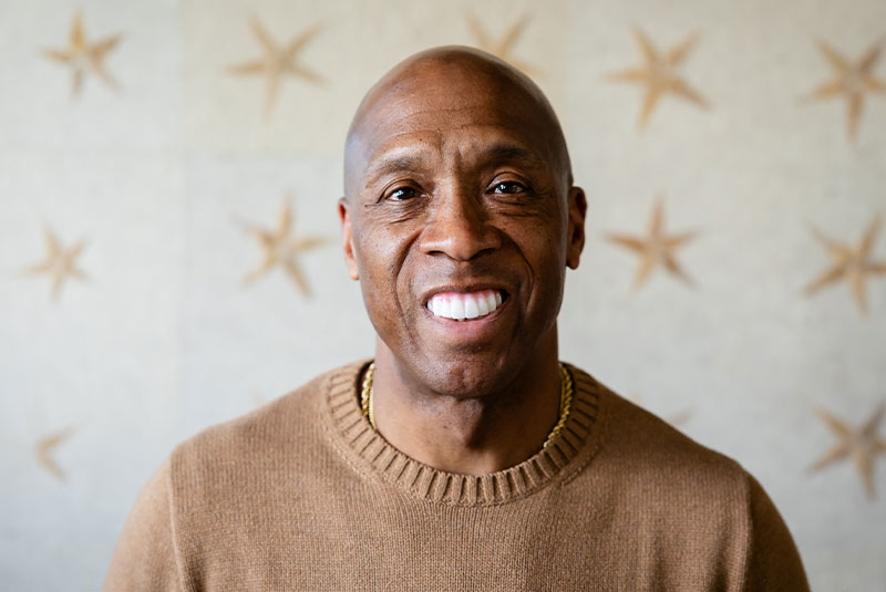 headshot of patient smiling brightly after their dental procedure