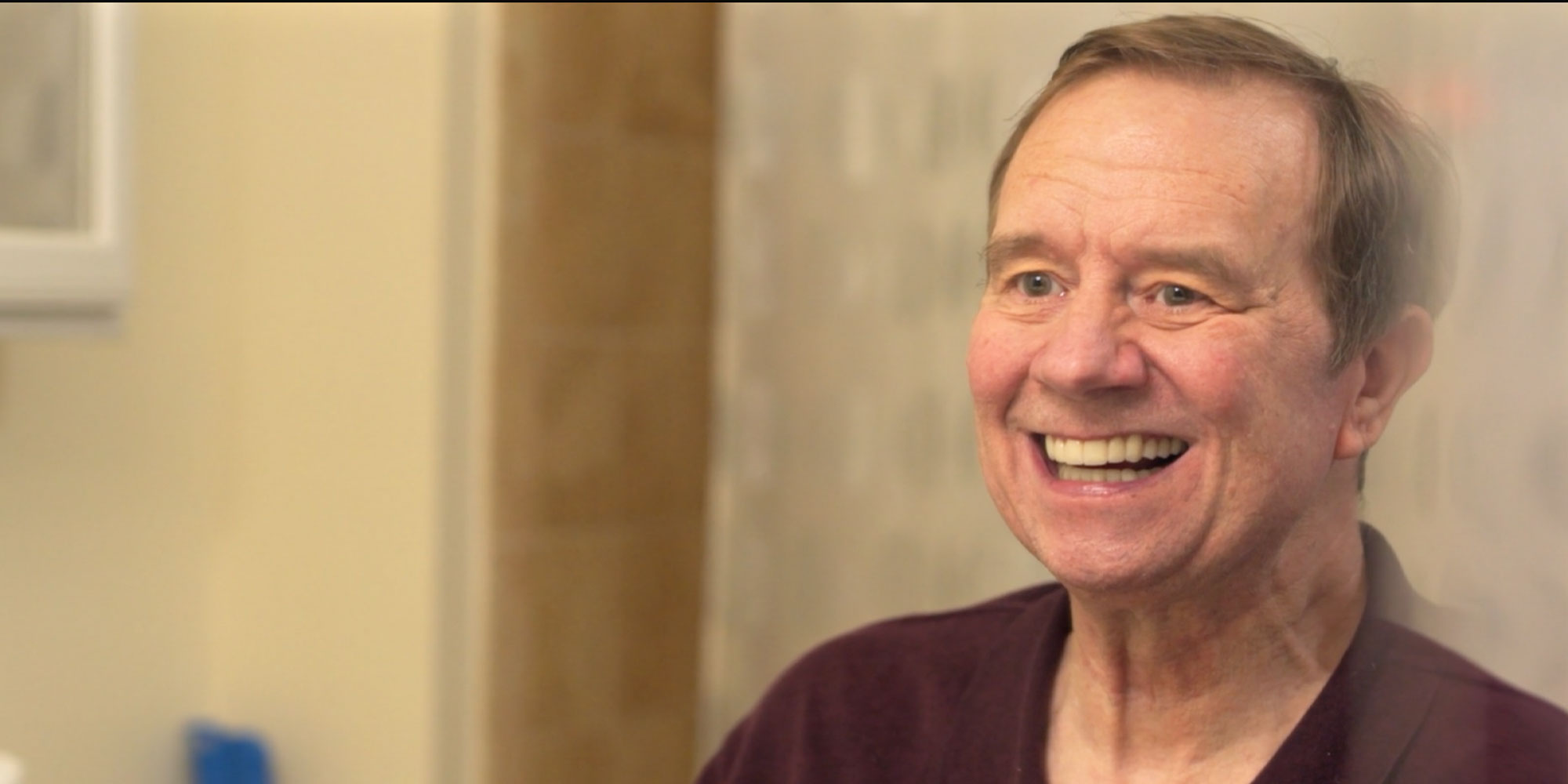 headshot of patient smiling within the dental center