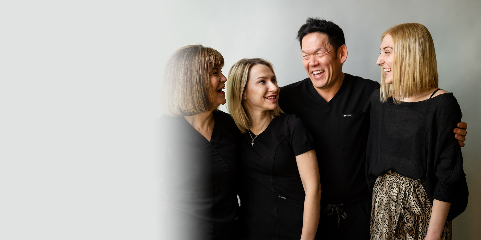 group of staff members of the dental center laughing and smiling for their phot shoot